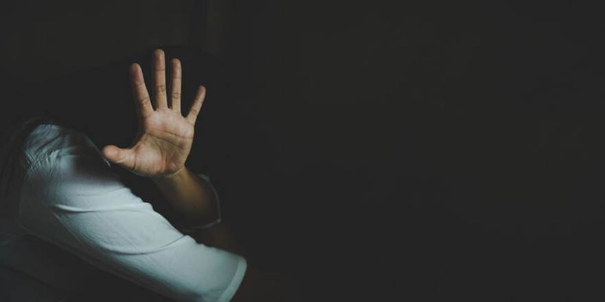 Woman hiding in the dark - Sexual Harassement